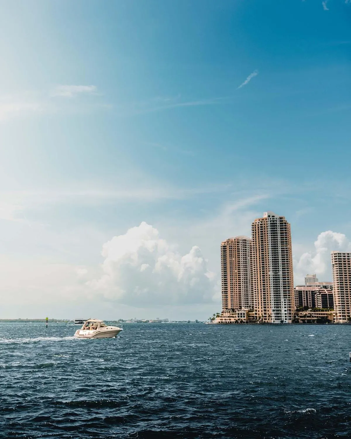 Speedboat crossing Biscayne Bay with downtown Miami towers beyond