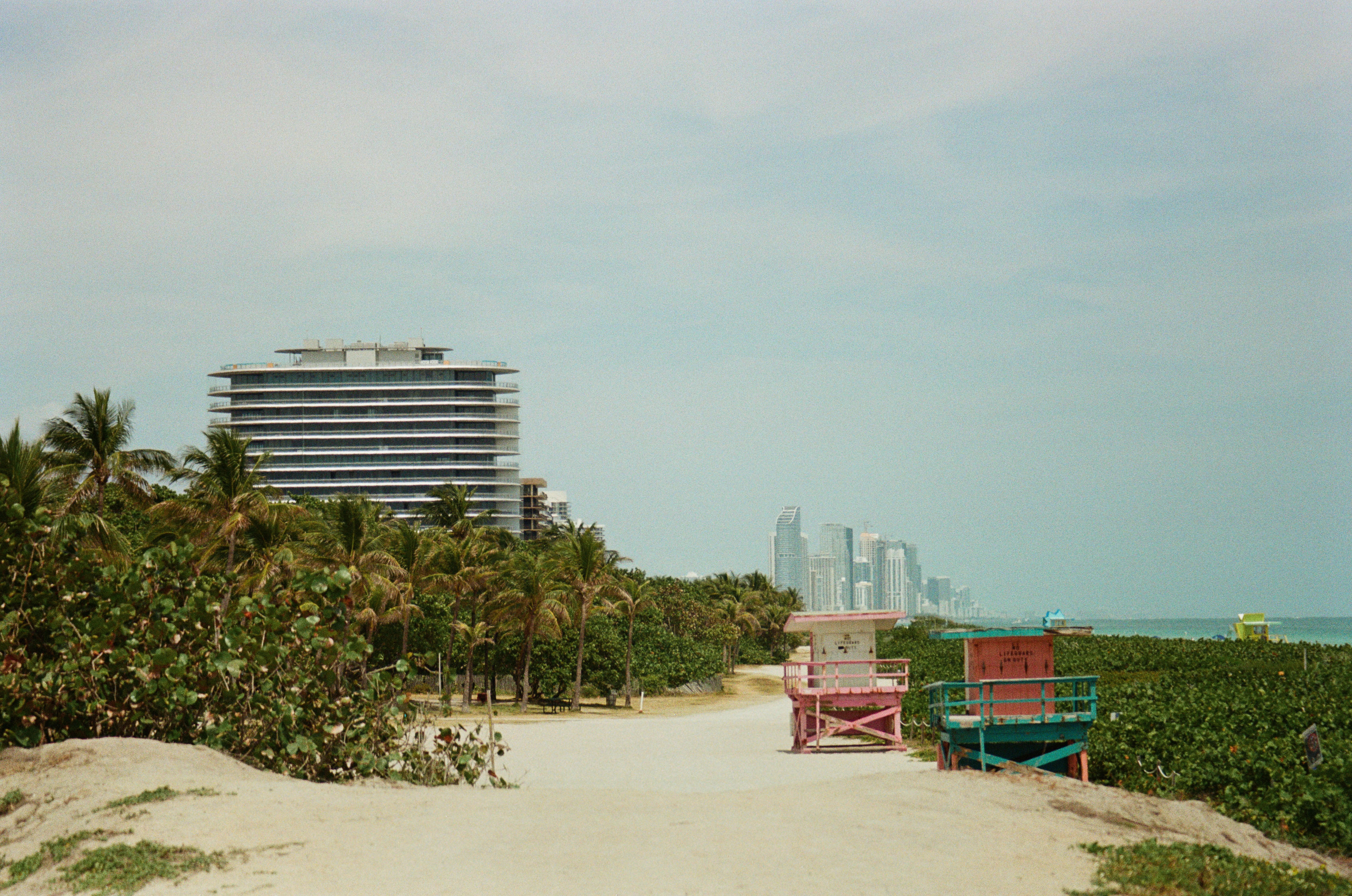 Beach path with Miami tower and lifeguard stand at South Beach