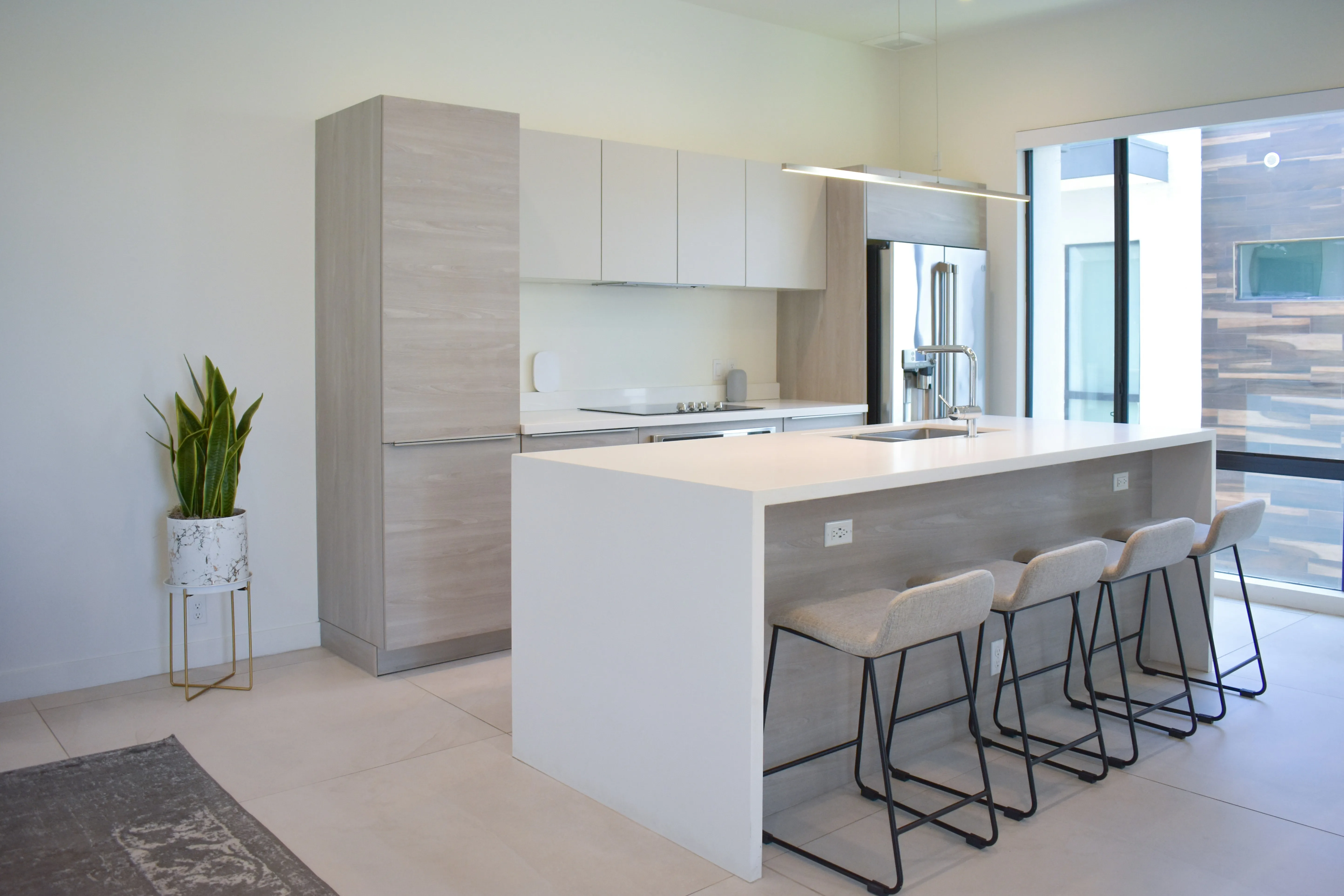 Open kitchen with island bench and floor-to-ceiling windows
